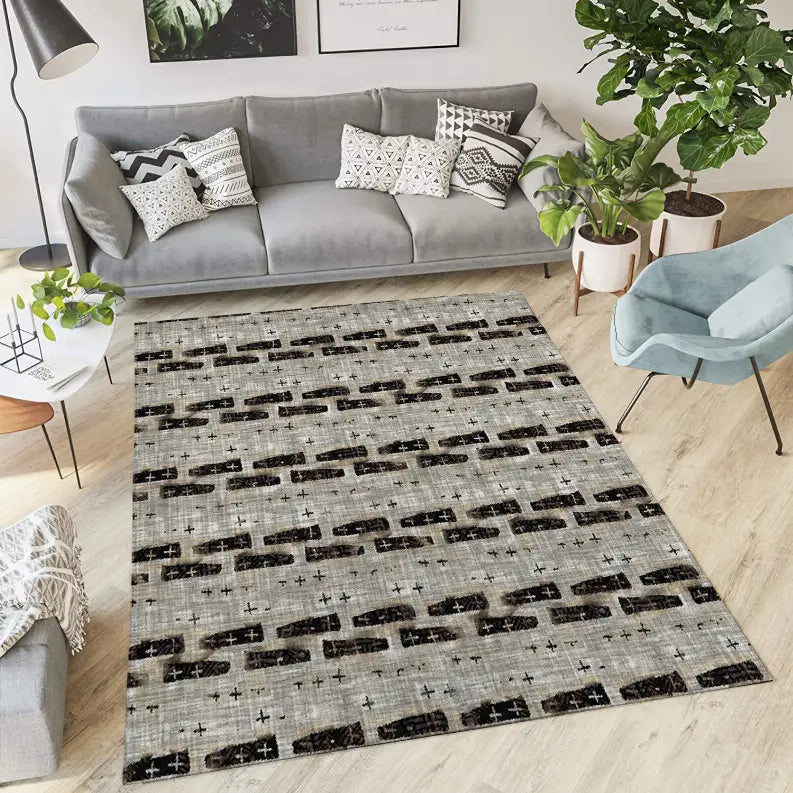 Modern beige area rug with black abstract patterns, ideal for contemporary living spaces. Perfect for adding style and comfort.