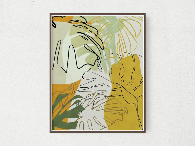 Abstract wall art featuring green, yellow, and beige tropical leaves in a modern style, framed for chic decor.