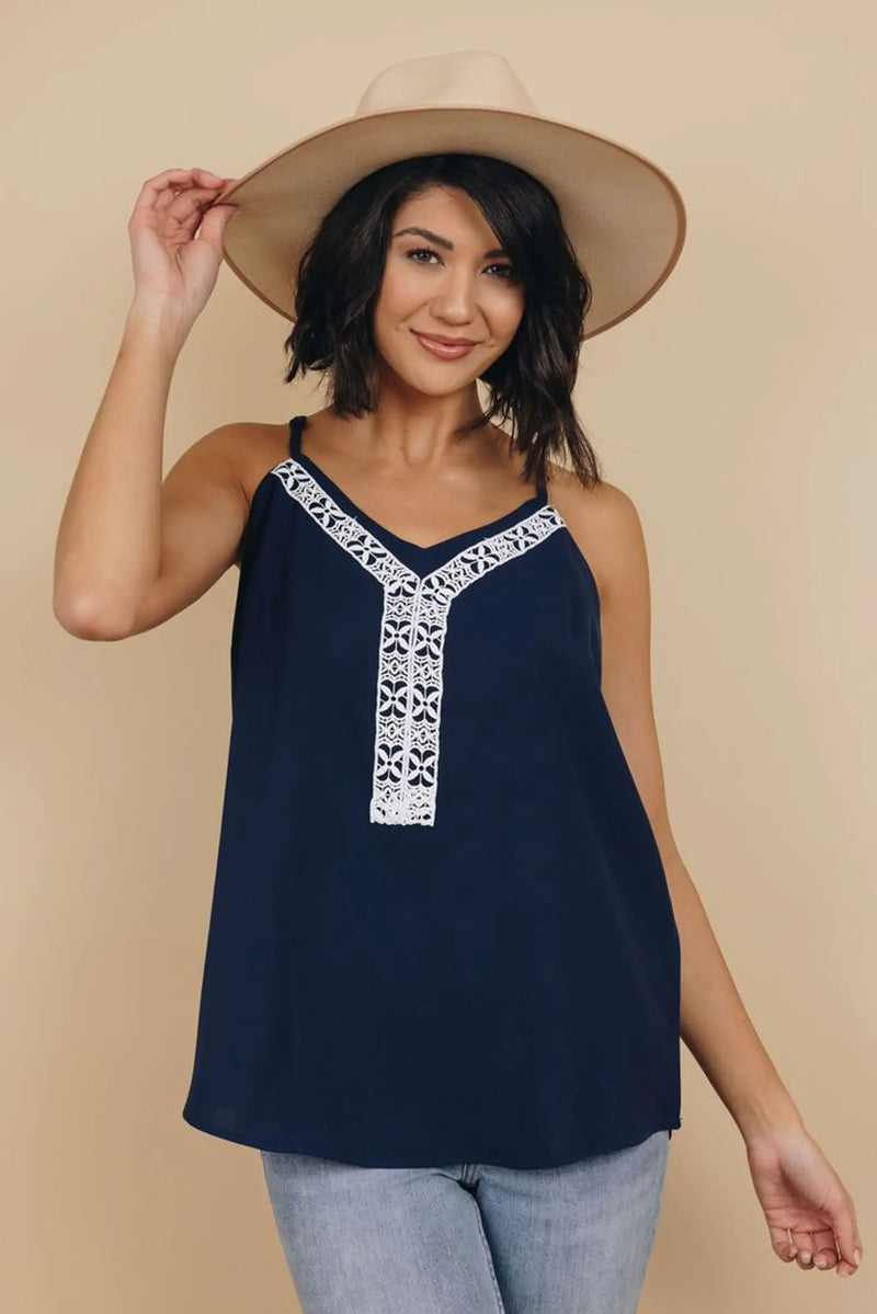 Navy blue sleeveless top with white embroidered detailing, relaxed fit, perfect for summer styling.