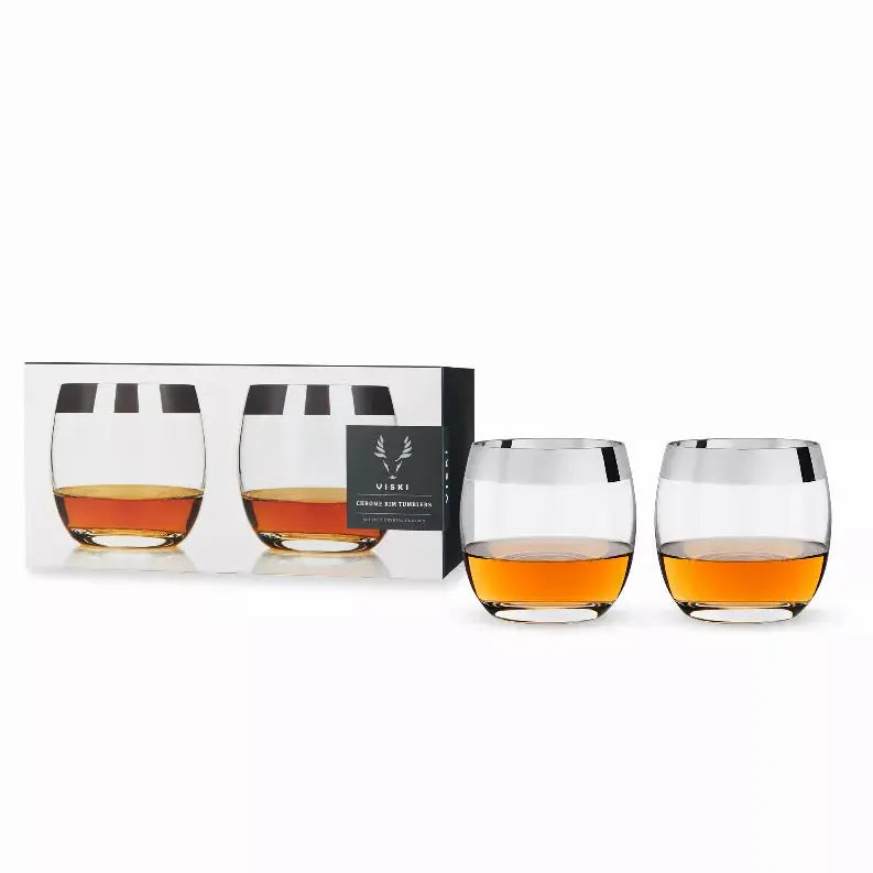 Set of 2 elegant crystal whiskey glasses with silver rims, featuring a curved design and showcasing amber liquid.
