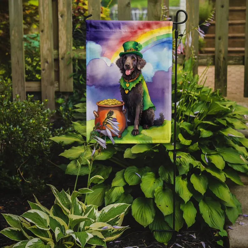 St. Patrick's Day garden flag featuring a black dog in a green cape by a pot of gold under a rainbow.