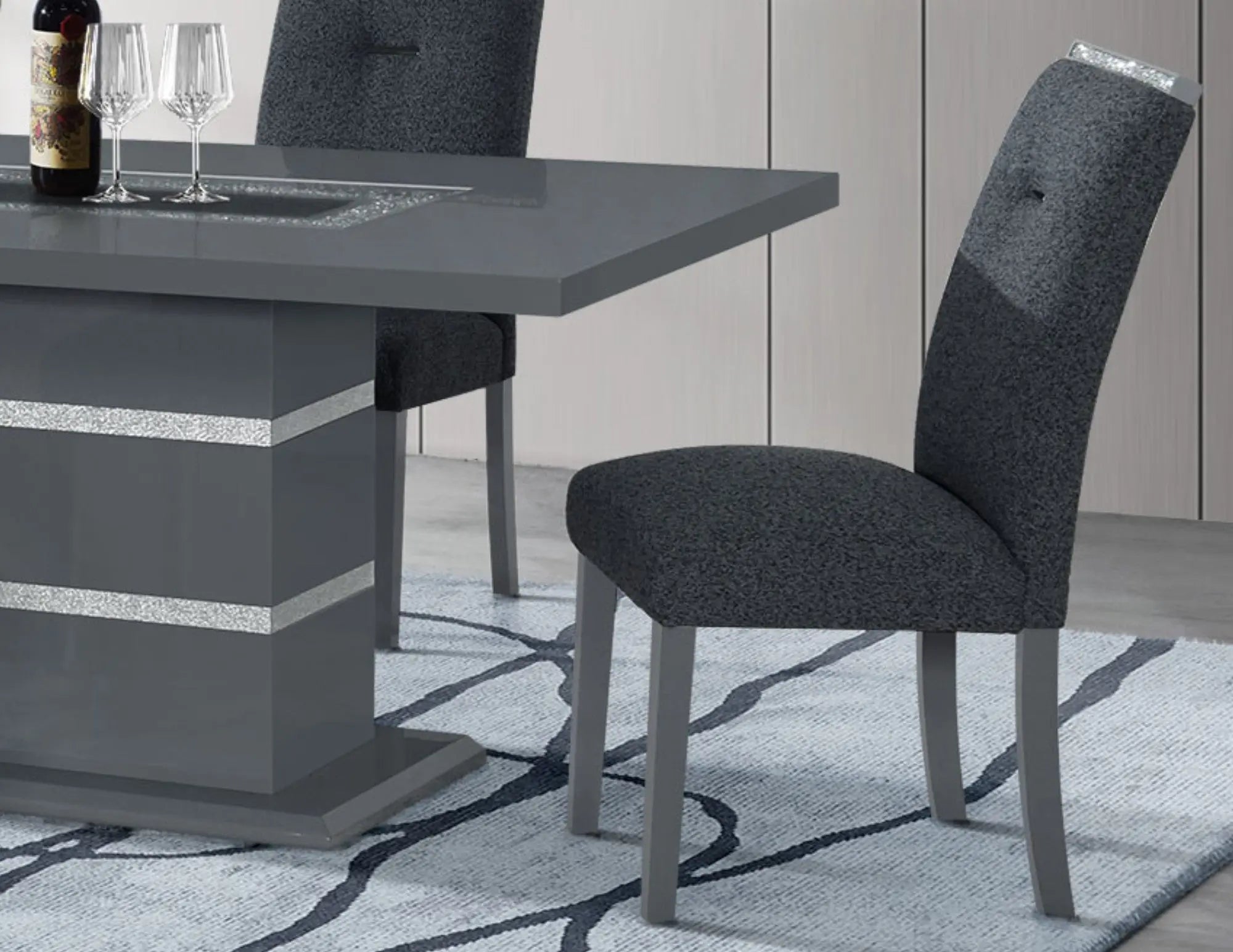Modern gray upholstered dining chair with sleek wooden legs and subtle glitter accents, set against a stylish rug.