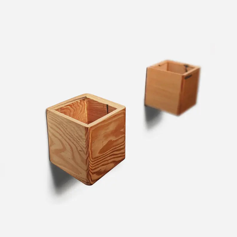 Natural wooden cube planters in light pine finish, perfect for modern home decor and indoor gardening.