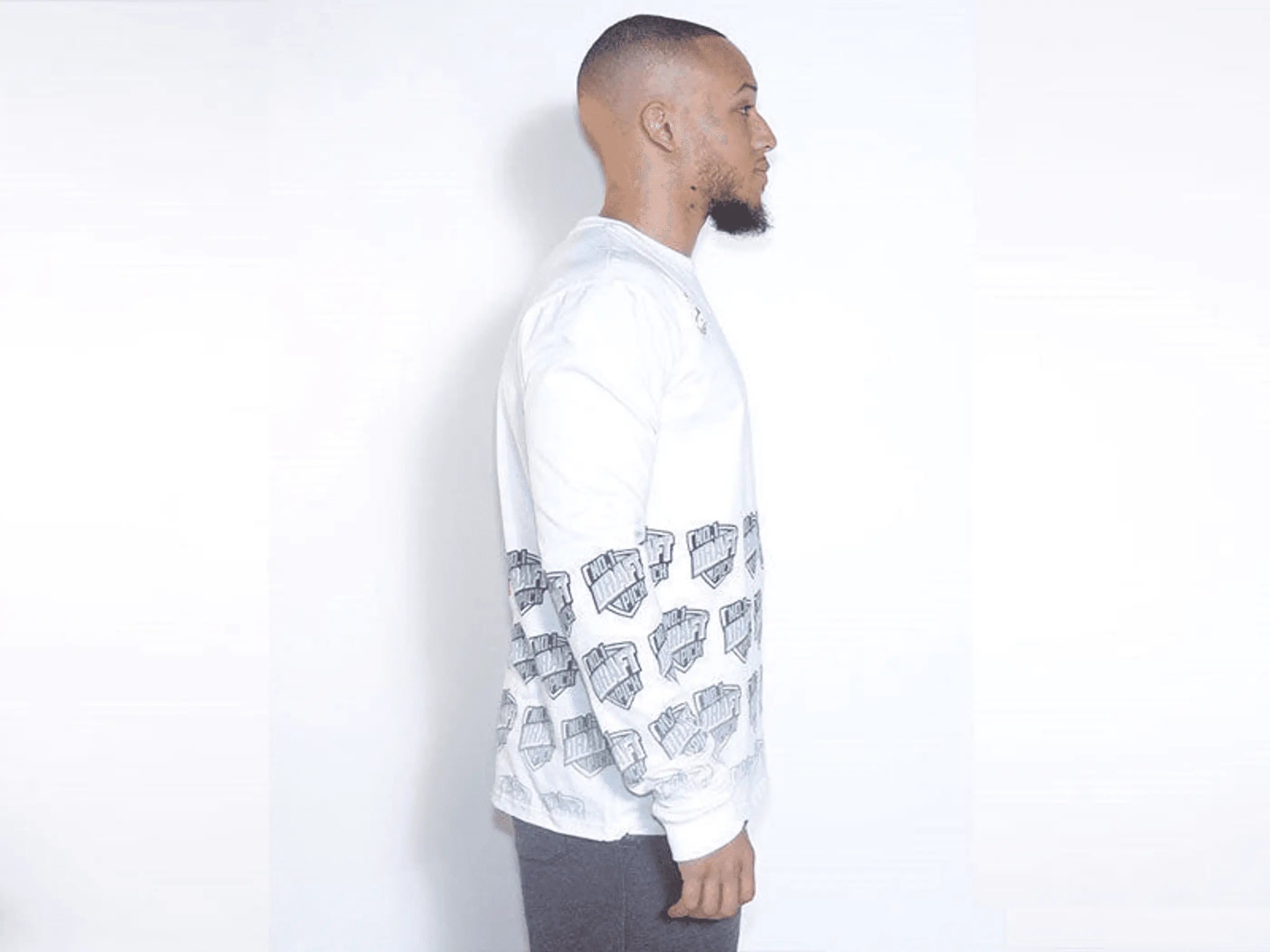 White long-sleeve shirt featuring gray graphic prints of cash stacks, perfect for casual streetwear style.