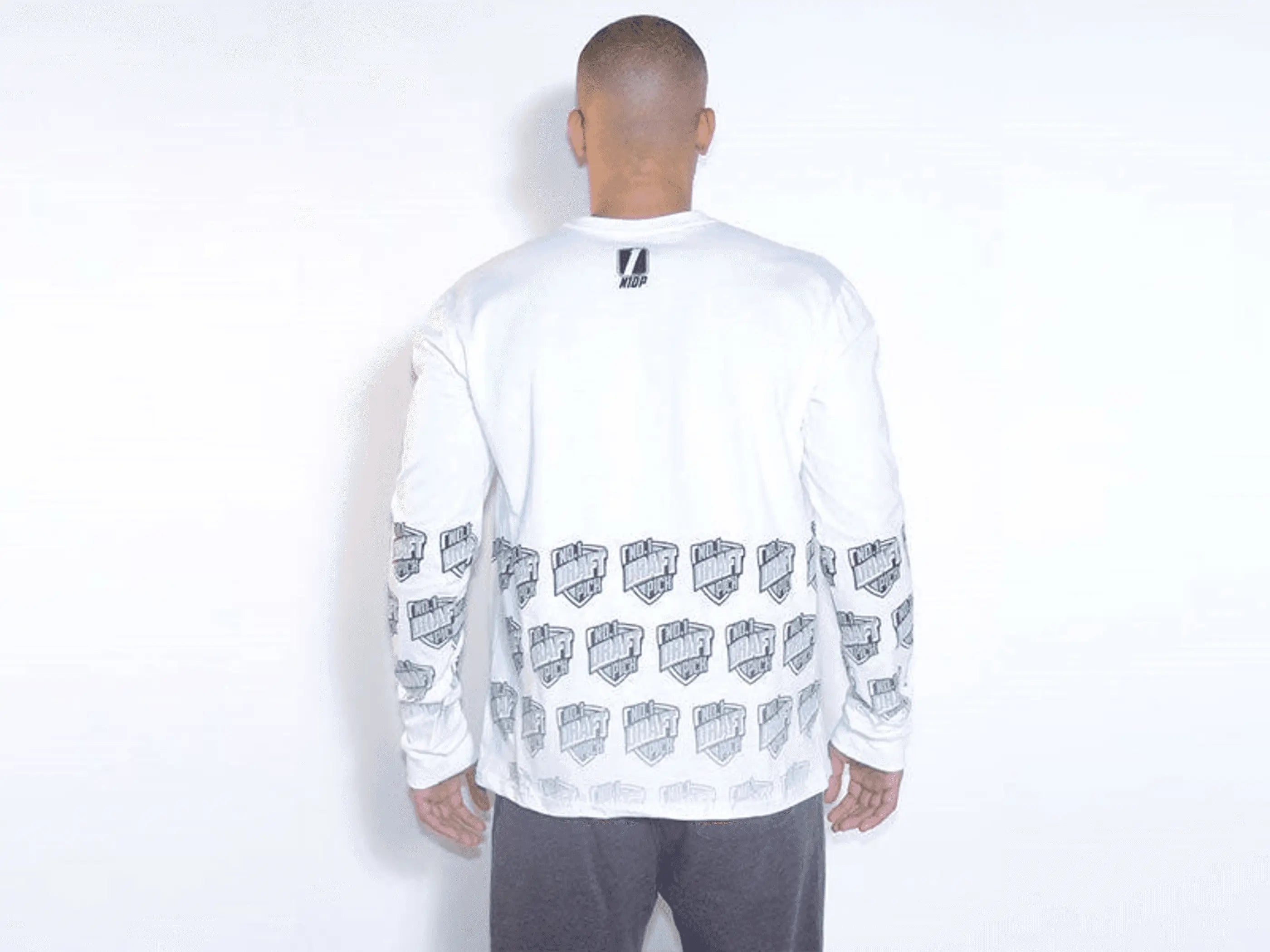 Men's white long sleeve shirt with graphic prints on sleeves, comfortable cotton material, and modern style.