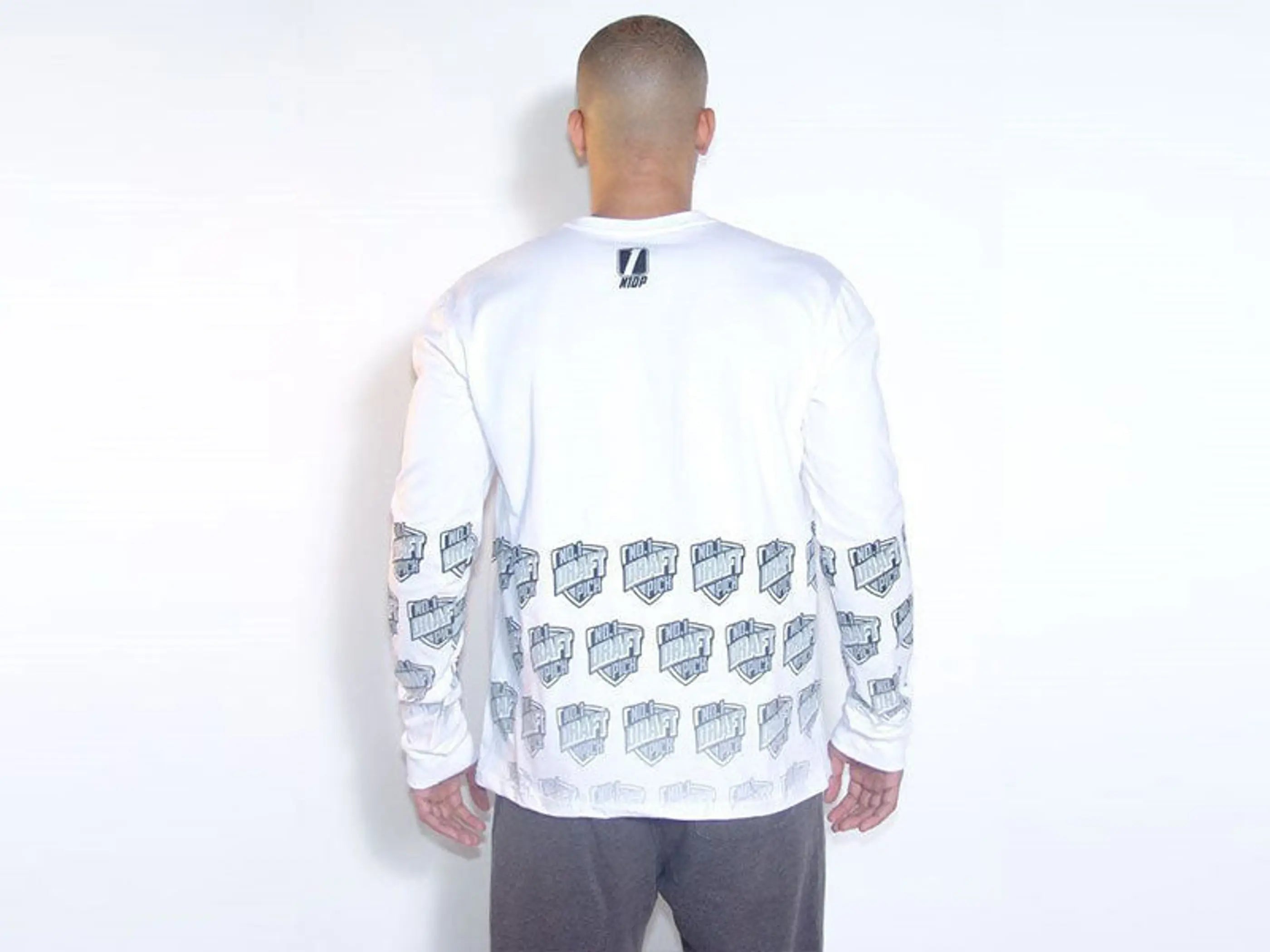 Men's white long sleeve shirt with graphic prints on sleeves, comfortable cotton material, and modern style.