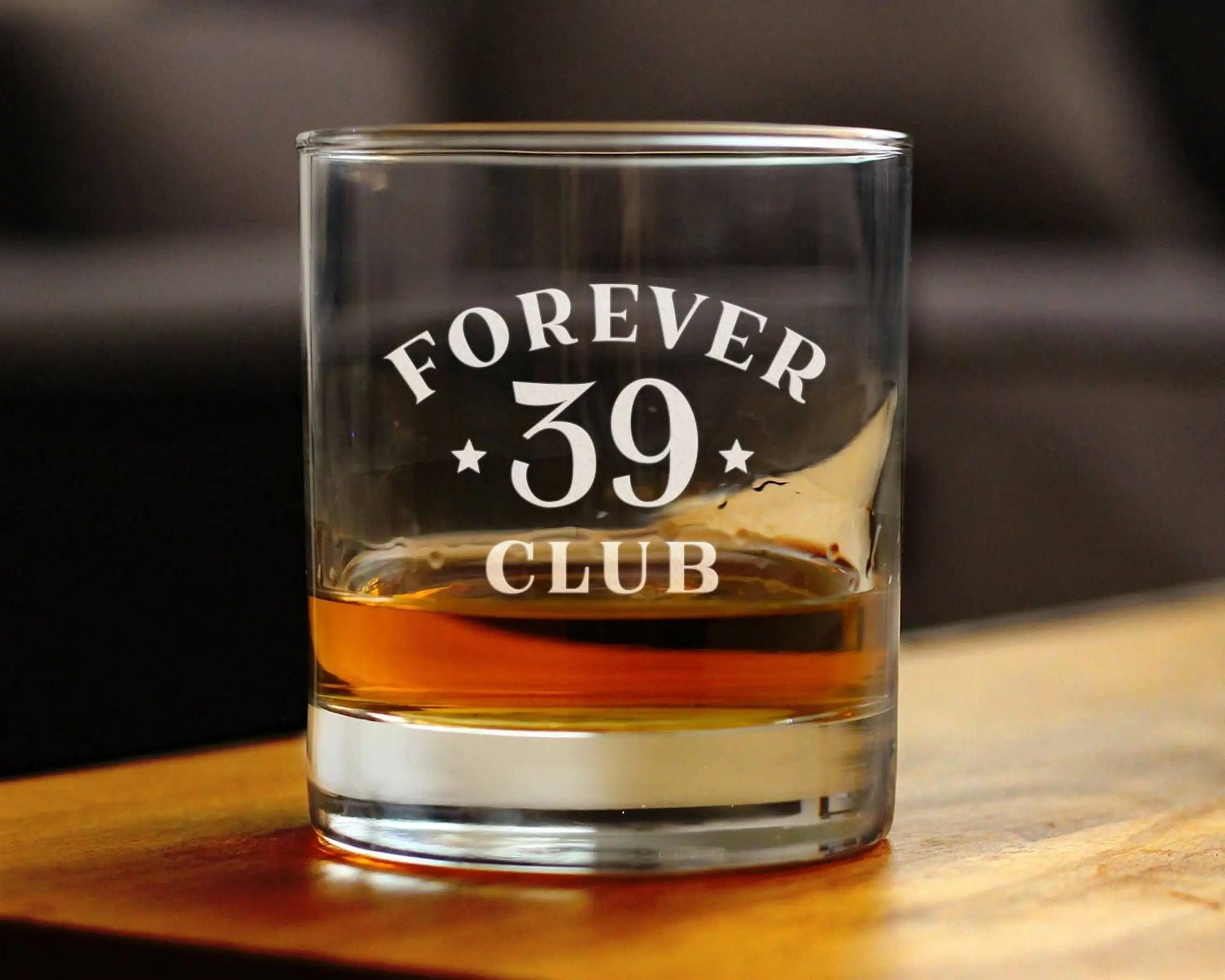 Clear glass whiskey tumbler with "FOREVER 39 CLUB" engraving, perfect for cocktail enthusiasts.