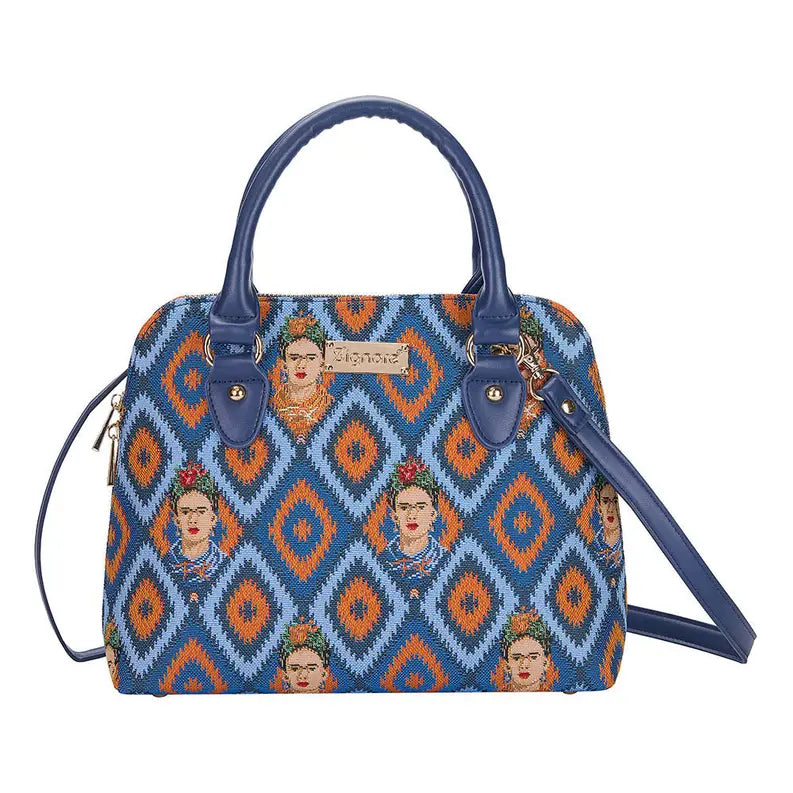 Blue patterned handbag with Frida Kahlo motifs, faux leather handles, and removable shoulder strap. Ideal for stylish outings.
