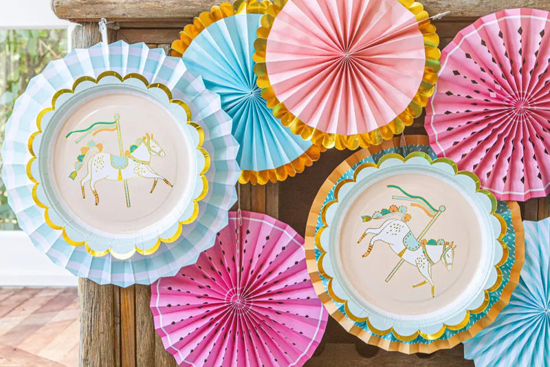 Colorful horse-themed paper plates with pink, blue, and gold accents, perfect for party decorations.