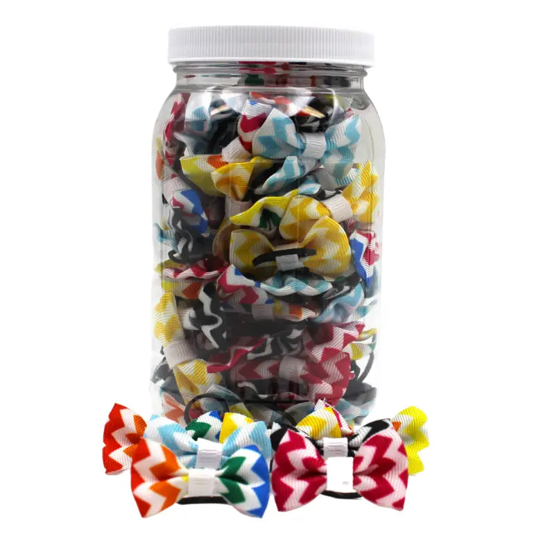 Colorful zigzag hair bows in a clear jar, showcasing red, yellow, green, and blue patterns. Perfect for kids' accessories.