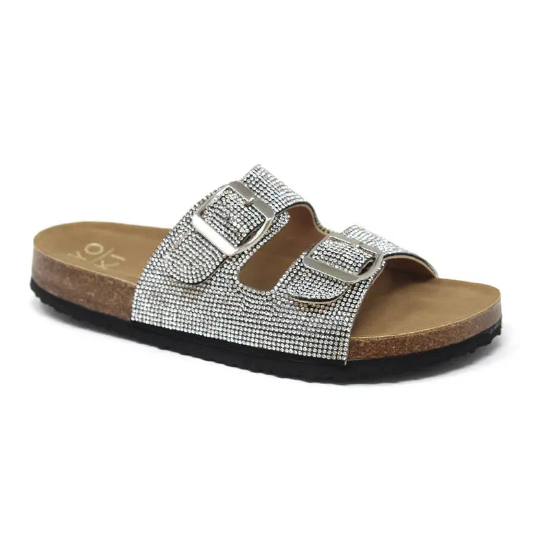 Silver embellished slide sandals with dual buckle straps and a cork footbed, perfect for casual and stylish summer wear.