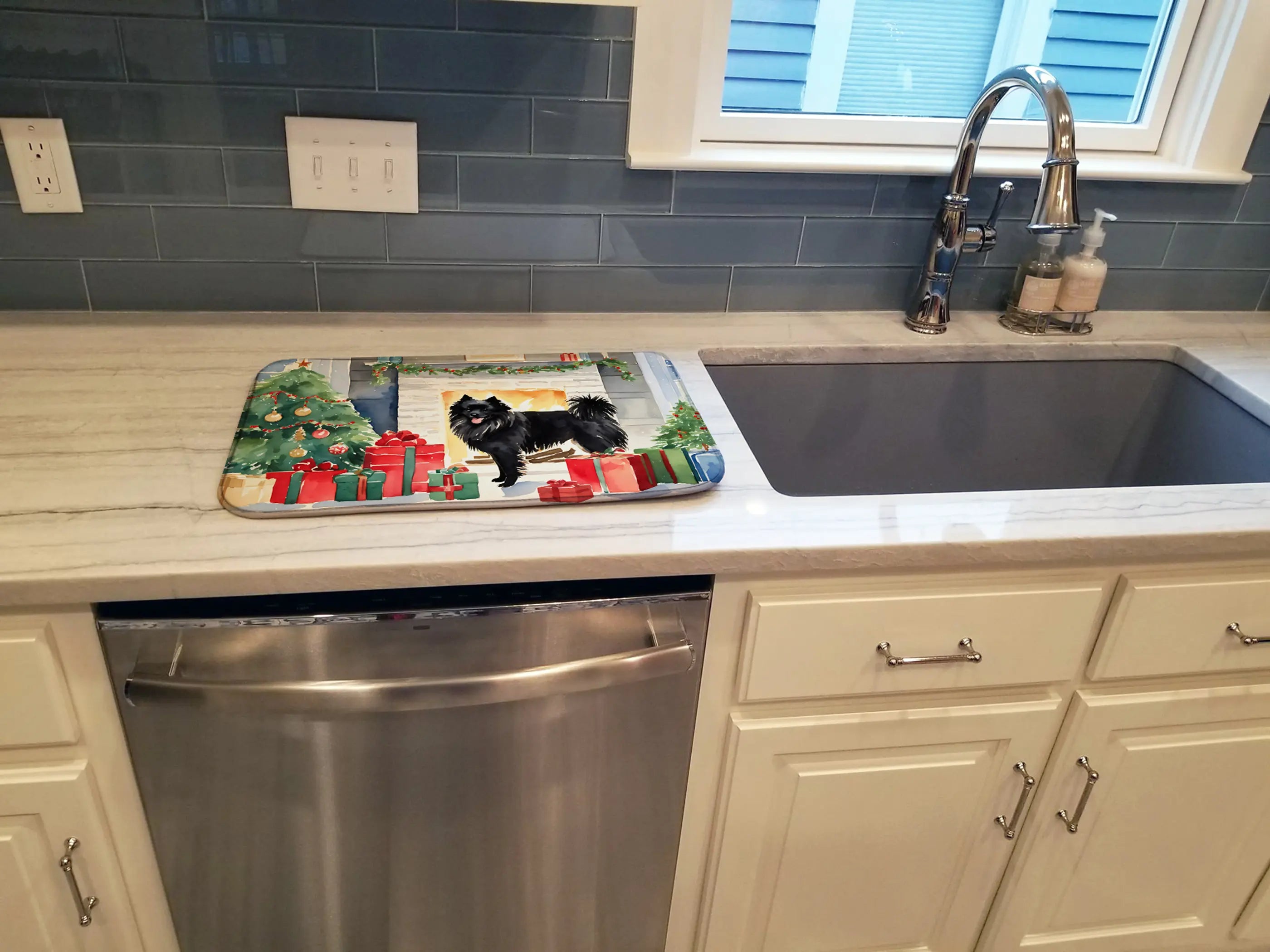 Black cat Christmas-themed kitchen mat with festive colors, durable fabric, and non-slip backing on a gray countertop.