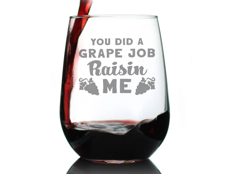Clear wine glass with humorous "You Did a Grape Job Raisin Me" text, featuring wine pouring and a grape design.