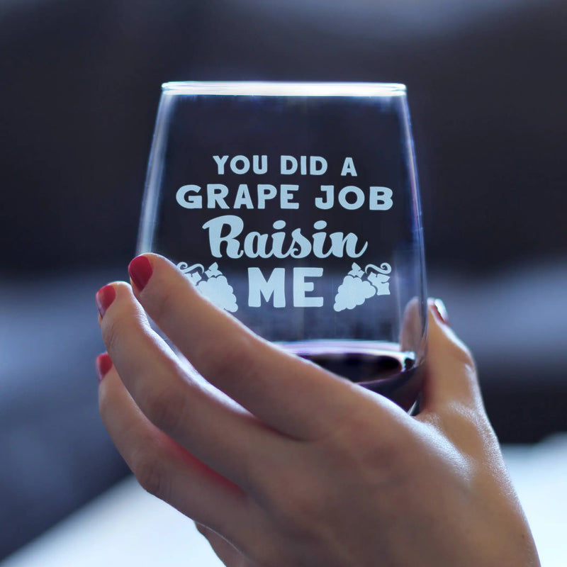 Clear wine glass with humorous text "You Did a Grape Job Raisin Me," held by a hand with red nail polish. Perfect gift.
