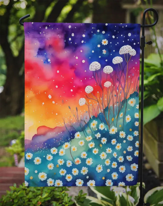 Colorful garden flag featuring white flowers and vibrant hues of orange, blue, and purple. Perfect for outdoor decor.