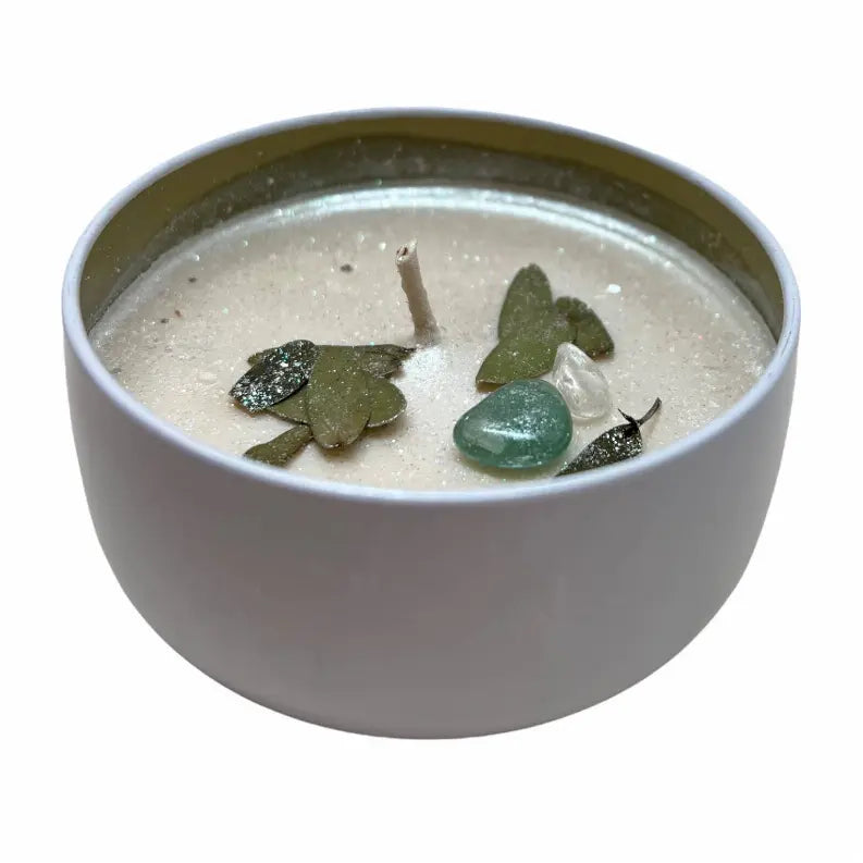 Natural soy candle in a chic gray jar with green leaves and decorative stones. Ideal for aromatherapy and decor.
