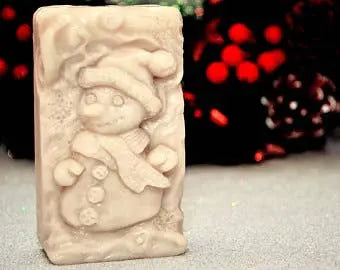 Snowman-shaped soap in light beige, featuring a festive hat and scarf, perfect for holiday gifting and décor.