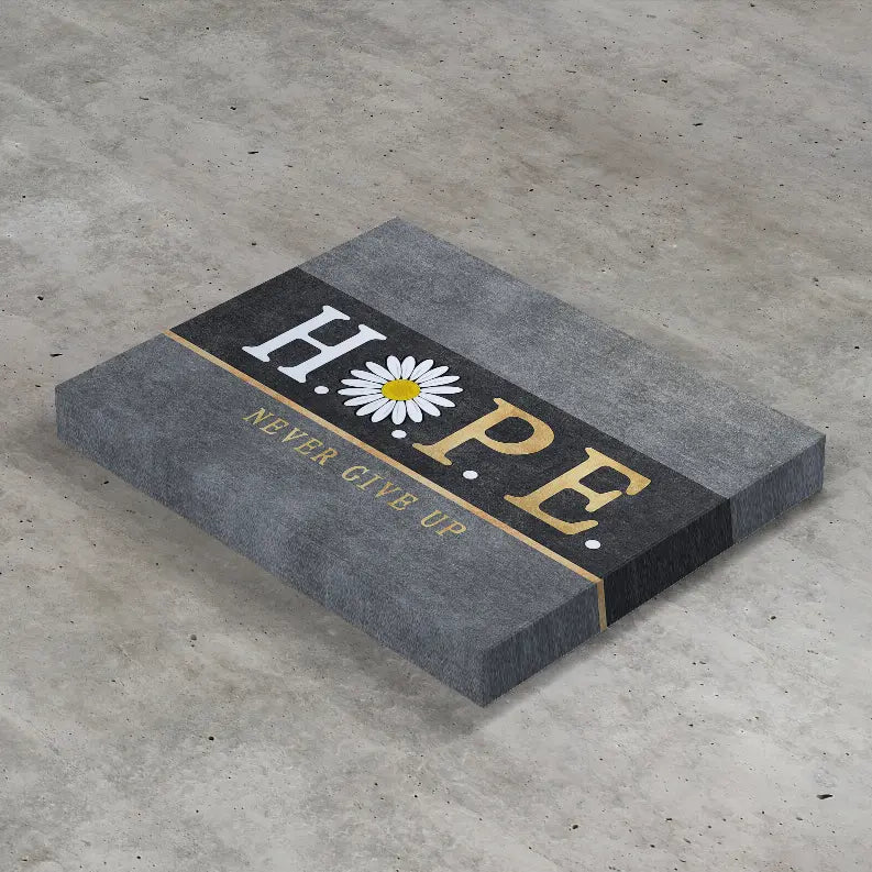 Gray stone plaque with gold lettering that says "HOPE" and a white daisy, featuring the phrase "NEVER GIVE UP."