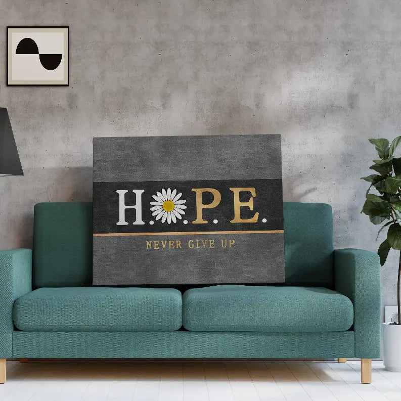 Black and gold "HOPE" canvas wall art with daisy, perfect for modern home decor, displayed above a teal sofa.