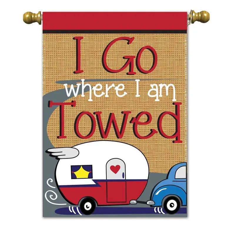 Colorful burlap-style garden flag featuring a whimsical camper and car with the text "I Go Where I Am Towed."
