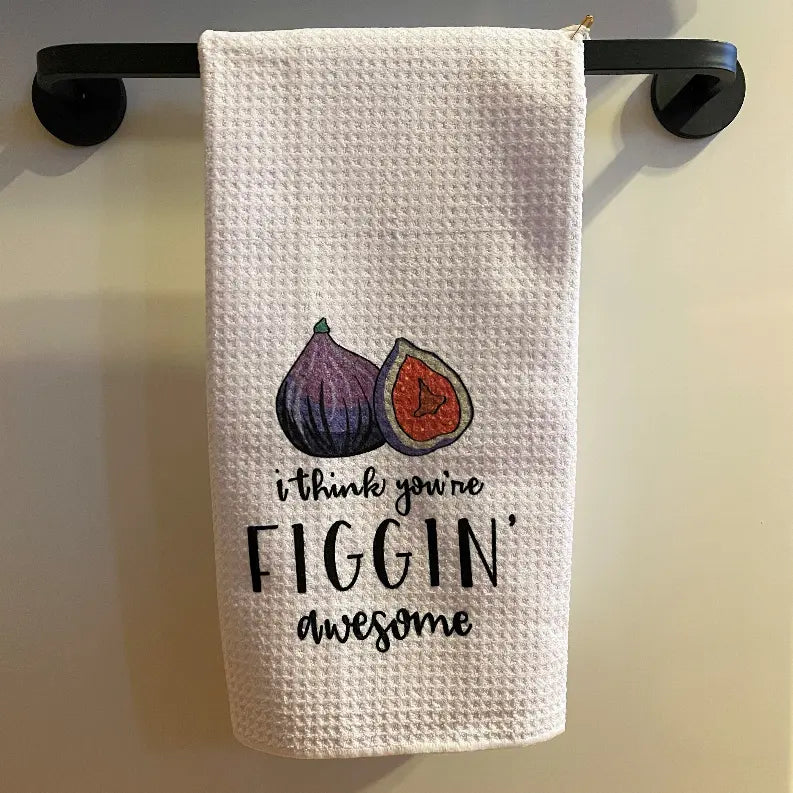 White waffle kitchen towel with fig illustrations and "I think you're figgin' awesome" text, perfect for quirky decor.