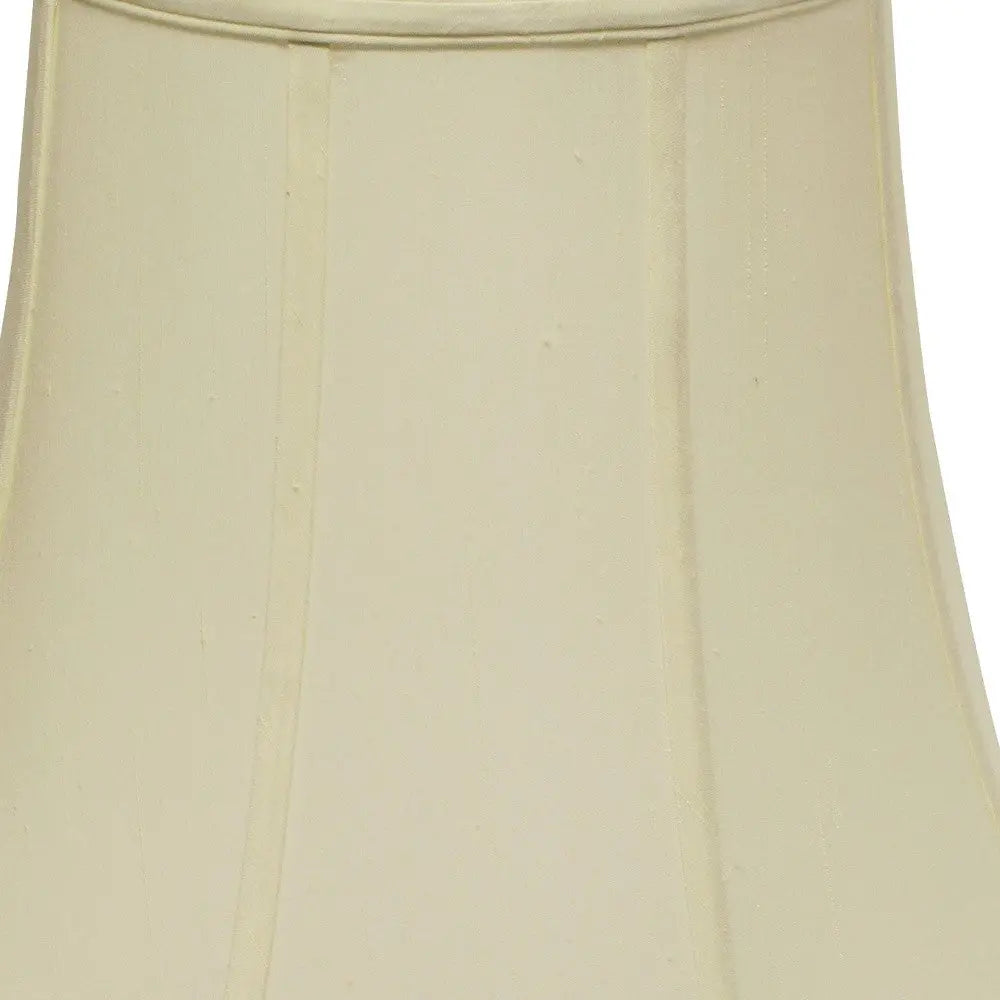 Ivory fabric lamp shade with a classic pleated design, ideal for stylish home decor and lighting solutions.