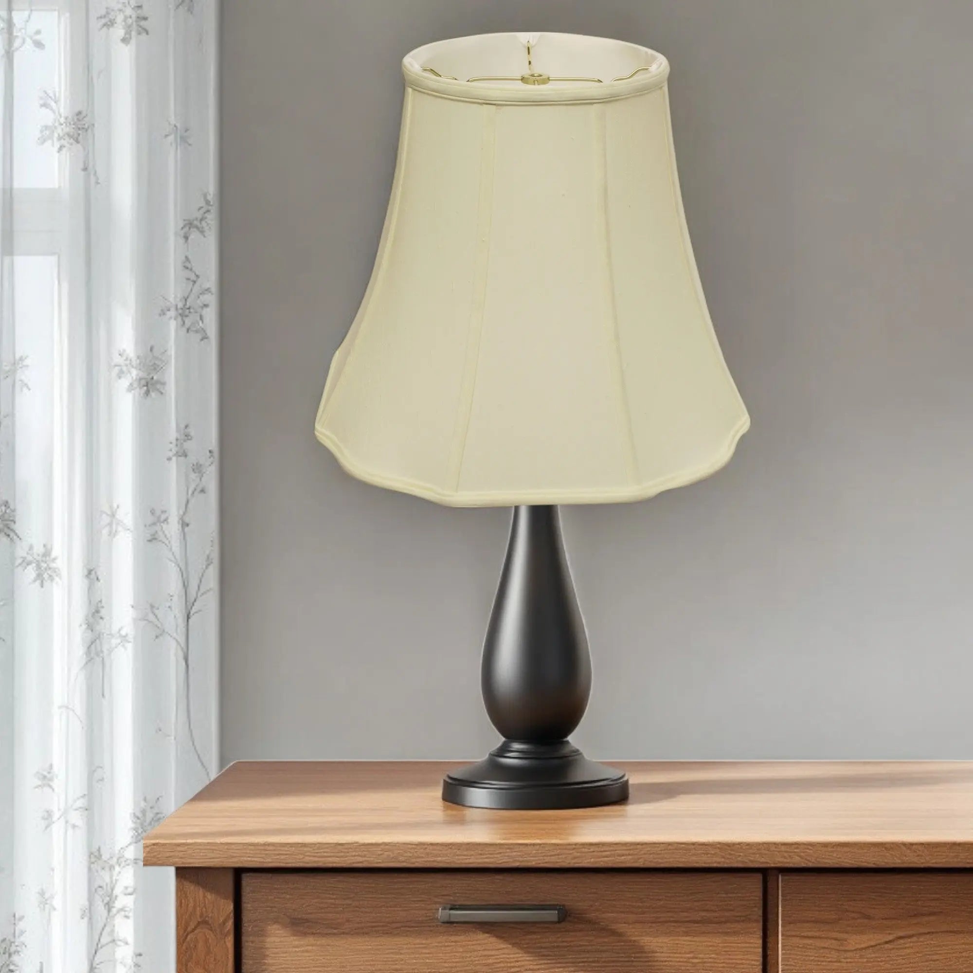 Elegant beige lampshade on a black metal base, perfect for adding style to any home decor.