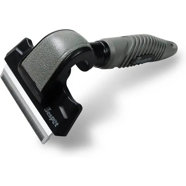 Gray ergonomic pet grooming tool with a stainless steel edge for de-shedding and removing loose fur.