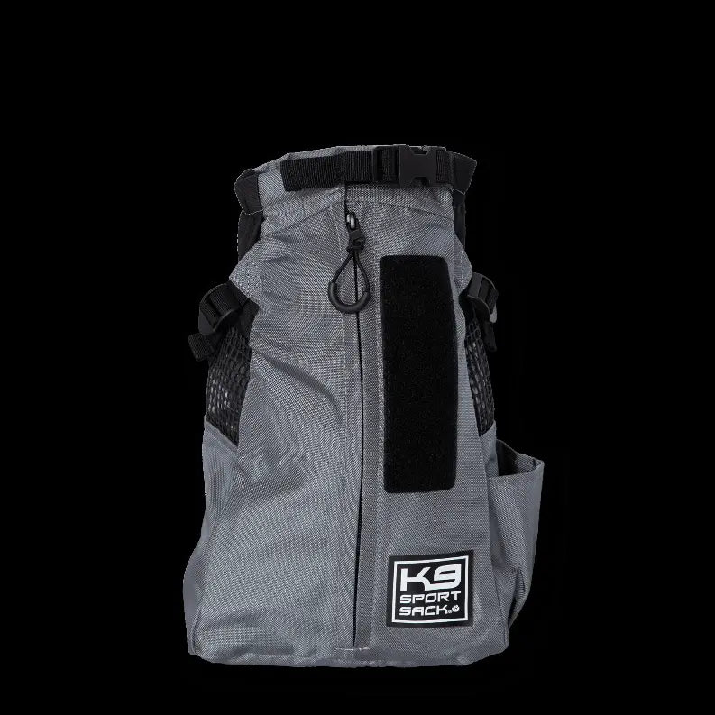 Gray K9 Sport Sack, durable fabric, backpack style, designed for pet carriers with mesh sides and adjustable straps.