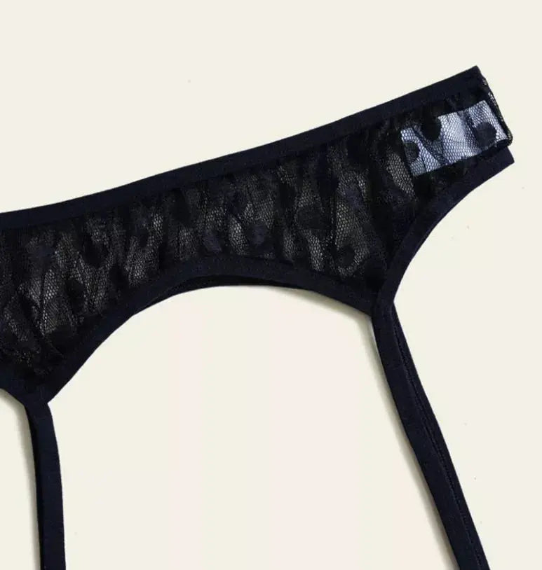 Black lace thong with sheer mesh detailing and elegant cut, perfect for a chic lingerie collection.