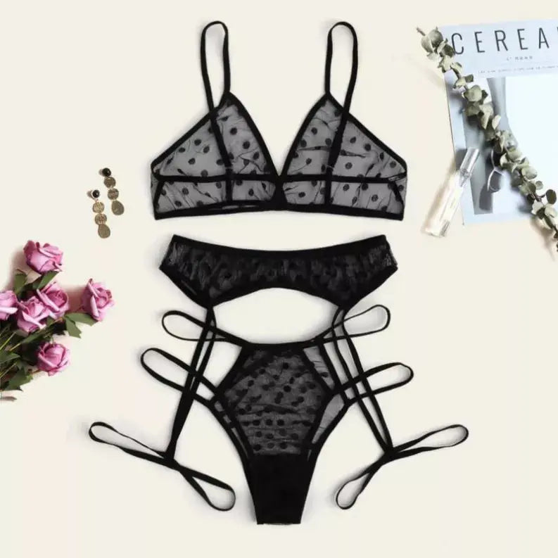 Black sheer mesh lingerie set with polka dots, featuring a triangle bralette and strappy thong, styled with floral accents.