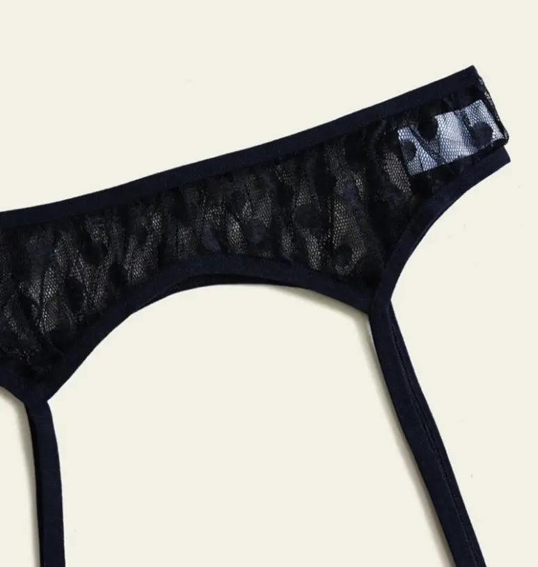 Black sheer lace thong with leopard print, featuring a delicate waistband and minimalist style.