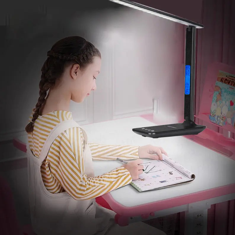 Kids' LED desk lamp in black and white with adjustable brightness, ideal for studying and reading at home.