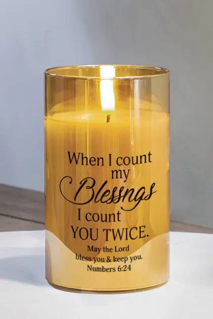 Gold glass candle with warm yellow wax and inspirational message, perfect for home decor and thoughtful gifting.