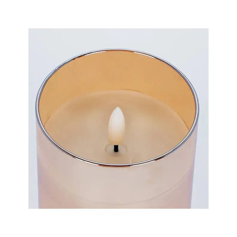 Elegant ivory candle in a rose gold glass holder, adding a touch of luxury to any decor.