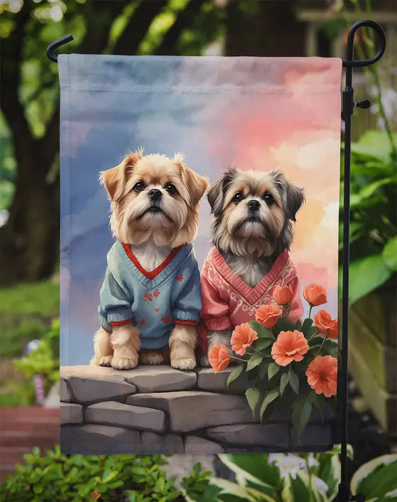 "Adorable garden flag featuring two dogs in colorful sweaters, surrounded by flowers, perfect for pet lovers."