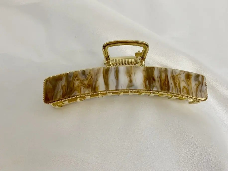 Marbled brown and cream hair claw clip with gold-tone detailing, perfect for elegant hairstyles.