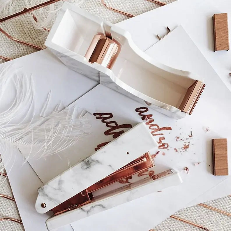 Marble-patterned stapler with rose gold accents, stylish office accessory for modern workspaces.