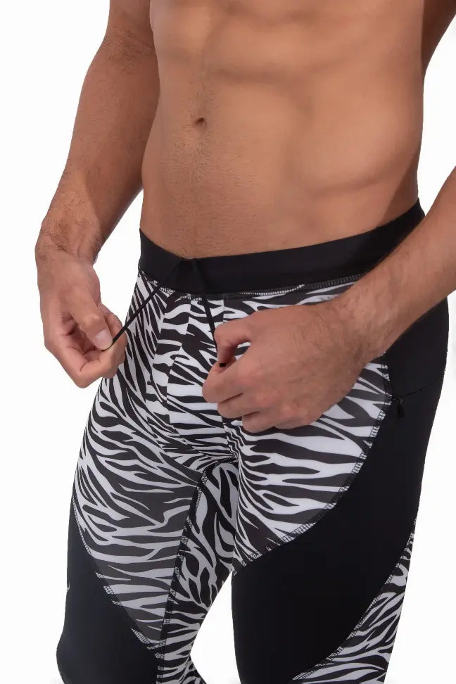 Men's black and white zebra print compression leggings, featuring stretchy fabric and a sleek, athletic design.