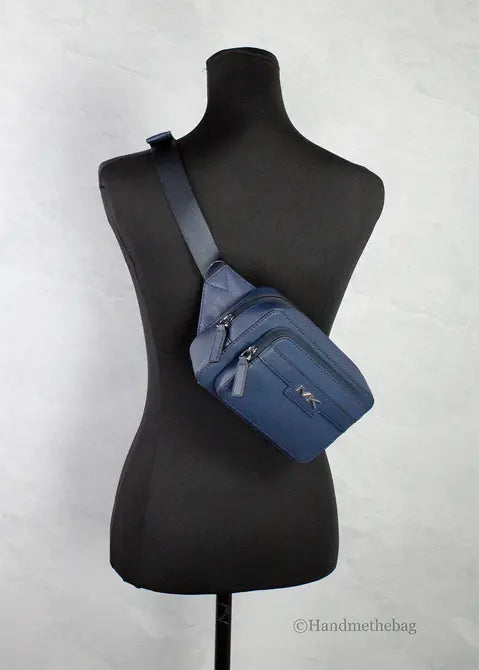 Navy blue leather crossbody bag with dual zippers and adjustable strap, perfect for casual outings.