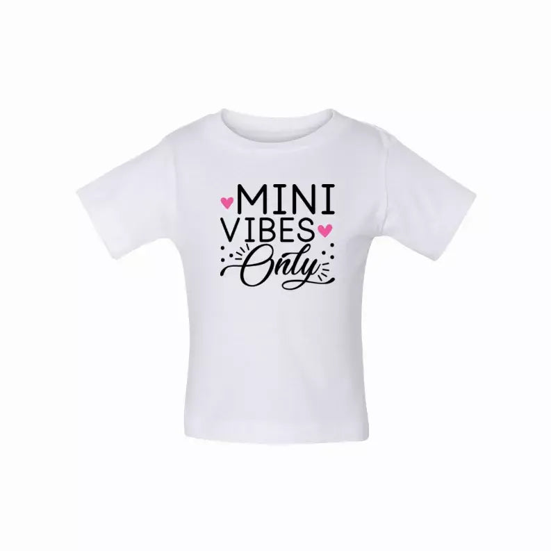 White toddler t-shirt featuring "Mini Vibes Only" in black and pink text, perfect for casual play.