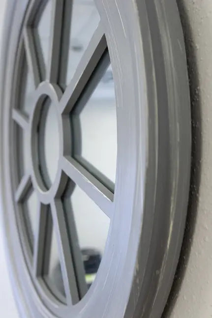 Gray wooden circular mirror with geometric design, featuring a modern, stylish frame. Perfect for home decor.