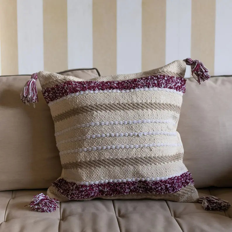 Bohemian striped throw pillow in cream, beige, and burgundy with textured accents, perfect for cozy home decor.