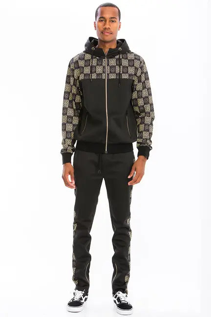 Men's black tracksuit set with gold logo print, featuring a zip-up hoodie and matching jogger pants. Casual stylish wear.