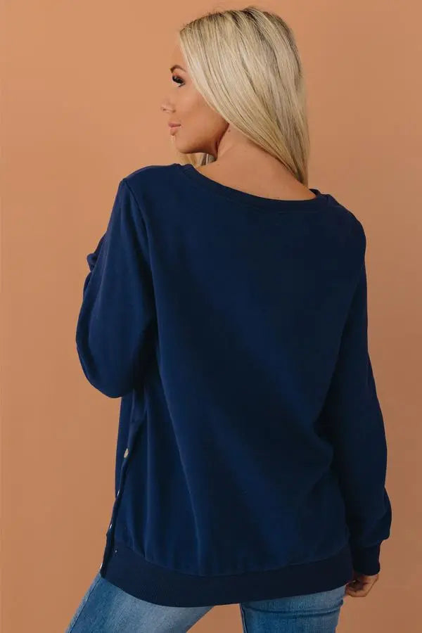 Navy blue oversized sweatshirt with button detail, crafted from soft cotton-blend fabric, perfect for casual wear.