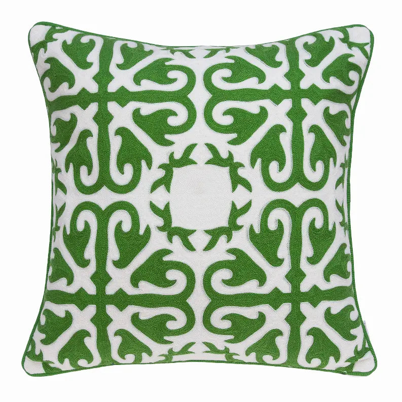 Green and white decorative pillow featuring a bold, intricate geometric pattern on soft fabric. Perfect for modern decor.