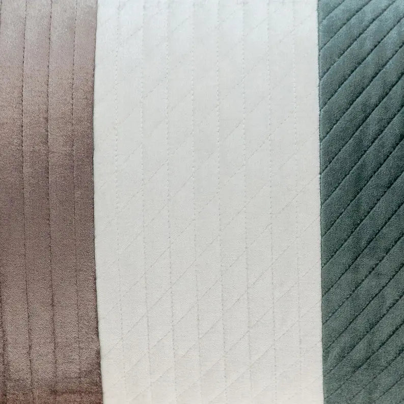 Plush velvet decorative pillow in taupe, white, and teal with a quilted diamond pattern. Ideal for modern home decor.