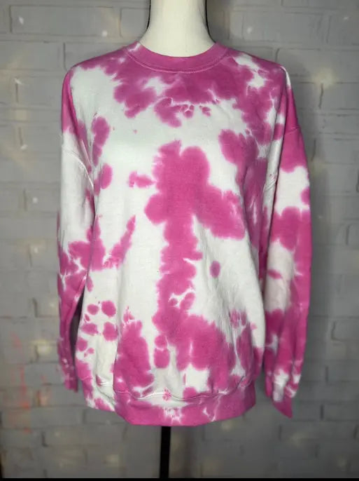 Pink and white tie-dye sweatshirt, cozy fleece material, oversized style perfect for casual wear.