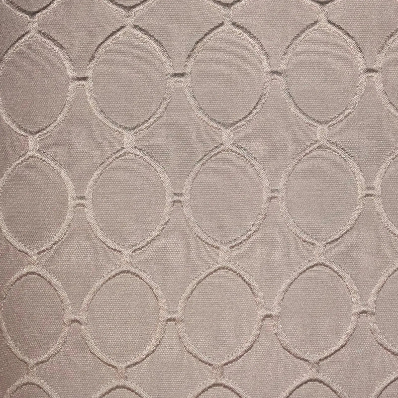 Light pink textured fabric with woven circle patterns, perfect for upholstery and home decor.