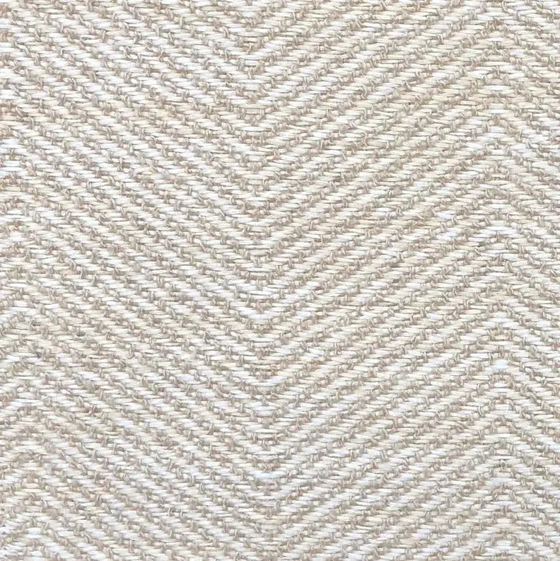 Beige herringbone woven fabric, ideal for upholstery and home decor, showcasing a textured, natural aesthetic.